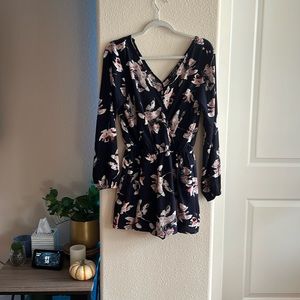 A summer styled romper with the v style cuts and pockets.